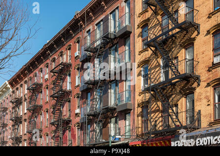 Facades with wrought-iron fire escapes on Bedford Avenue in Williamsburg, Brooklyn, New York City, USA Stock Photo