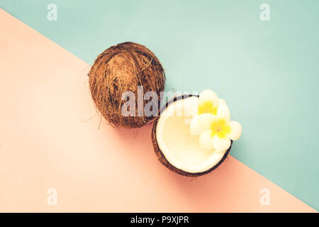 coconut cracked fruit, top view scene minimal style on pink and blue background, retro toned Stock Photo
