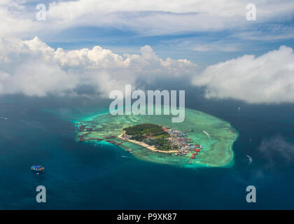 A distant drone photo of Mabul Island in Sabah, Malaysia (Borneo), with blue sky and clouds above. Stock Photo