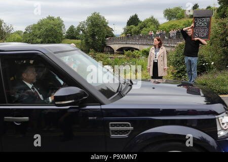 A man holds a sign saying 'customs stop' written in both English and Irish as Prime Minister Theresa May leaves following a visit to Belleek pottery factory on the northern side of the border between Enniskillen in Northern Ireland and Ballyshannon in Donegal. Stock Photo