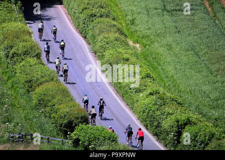 Corfe, Dorset, England - June 03 2018: Aerial view of a group of cyclists on a road race through English fields Stock Photo