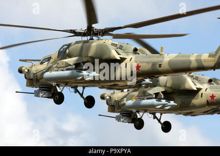 Two Mil Mi-28 all-weather, day-night, military tandem, two-seat anti-armor attack helicopters of Russian Air Force fly in formation at the MAKS airsho Stock Photo