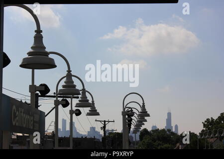 Chicago skyline and Willis Tower as seen from the CTA Blue Line California train station in Chicago, Illinois on a sunny summer day. Stock Photo