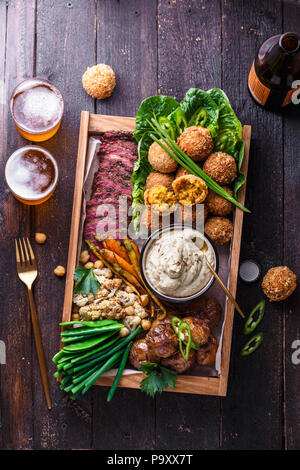 Assorted middle eastern dishes: falafel, meat, potato, cauliflower and babaghanoush Stock Photo
