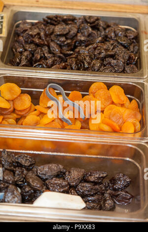 Dry Prunes And Dry Apricots in plastic container on display . Stock Image. Stock Photo