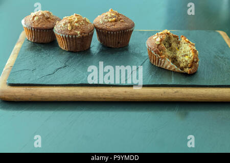 Display of banana walnut muffins on a cutting board. Stock Photo
