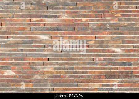 Dark brown, yellow brick wall with yellow cement background. Stock Photo