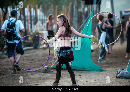 A young woman juggling with two hula hoops at the same time at the Lost