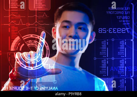 Portrait of a young man smiling and touching the round diagram Stock Photo