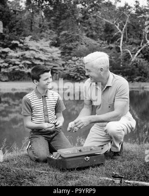 1960s GRANDFATHER AND GRANDSON SELECTING EQUIPMENT FROM A FISHING TACKLE BOX - a7073 HAR001 HARS TACKLE SENIOR MAN SENIOR ADULT B&W HAPPINESS OLDSTERS OLDSTER LEISURE AND RECREATION ELDERS CONNECTION GRANDFATHERS GRANDSON RELATED 1960s GRANDFATHER AND GRANDSON SELECTING EQUIPMENT FROM A FISHING TACKLE BOX - a7073 HAR001 HARS TACKLE SENIOR MAN SENIOR ADULT B&W HAPPINESS OLDSTERS OLDSTER LEISURE AND RECREATION ELDERS CONNECTION GRANDFATHERS GRANDSON RELATED