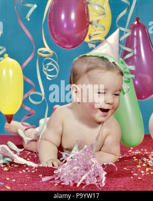1960s BABY GIRL LAUGHING WEARING PARTY HAT AMID STREAMERS AND BALLOONS - kn374 HAR001 HARS FEMALES STREAMERS STUDIO SHOT COPY SPACE HALF-LENGTH EXPRESSIONS HAPPINESS CHEERFUL AND EXCITEMENT PARTIES SMILES INTOXICATED INEBRIATED JOYFUL JUVENILES AMID BABY GIRL CAUCASIAN ETHNICITY HAR001 OLD FASHIONED Stock Photo