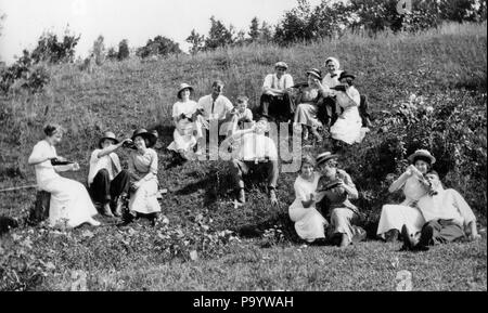 1890s 1900s TURN OF THE 20TH CENTURY GROUP OF COUPLES MEN & WOMEN DRINKING MANY BOTTLES OF ADULT BEVERAGES SITTING ON HILLSIDE  - o3624 LEF001 HARS YOUNG ADULT BALANCE COMIC TEAMWORK RELAXING PLEASED JOY LIFESTYLE CELEBRATION FEMALES RURAL GROWNUP HORIZONTAL COPY SPACE FRIENDSHIP FULL-LENGTH PERSONS RISK SUNNY B&W MEN AND WOMEN FREEDOM TEMPTATION ALCOHOLIC HUMOROUS HAPPINESS CHEERFUL ADVENTURE BEVERAGE LEISURE TURN OF THE 20TH CENTURY AND RECREATION COMICAL SMILES COMEDY ESCAPE JOYFUL LAUGHTER MEMBERS STYLISH SPIRITS DAYLIGHT HILLSIDE MEMBER RELAXATION TOGETHERNESS WINEGLASS WINES Stock Photo