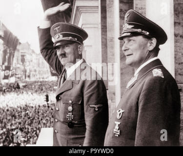 1930s 1940s ADOLF HITLER AND HERMANN GOERING ON BALCONY WAVING TO CROWD CIRCA 1938  - q72076 CPC001 HARS POWERFUL WORLD WARS WORLD WAR WORLD WAR TWO WORLD WAR II DICTATOR AUTHORITY FACIAL HAIR OCCUPATIONS POLITICS UNIFORMS 1938 NAZI WORLD WAR 2 ADOLF HITLER CIRCA MOUSTACHED SALUTING BLACK AND WHITE CAUCASIAN ETHNICITY OLD FASHIONED Stock Photo