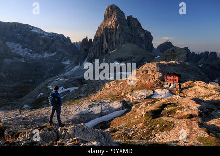 Hiker enjoying the morning view of croda dei toi and rifugio poan di cengia Stock Photo