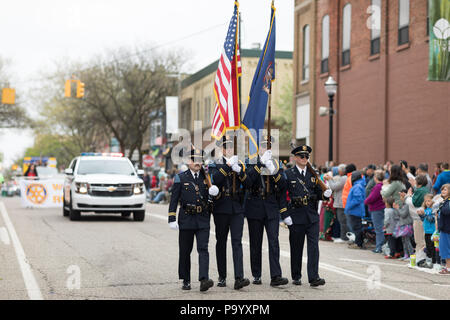 Holland, Michigan, USA - May 12, 2018 Police Officers from Holland MI carry the american flag at the Muziek Parade, during the Tulip Time Festival Stock Photo