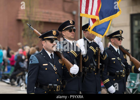 Holland, Michigan, USA - May 12, 2018 Police Officers from Holland MI carry the american flag at the Muziek Parade, during the Tulip Time Festival Stock Photo