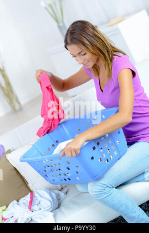 young happy woman laundering clothes at home Stock Photo
