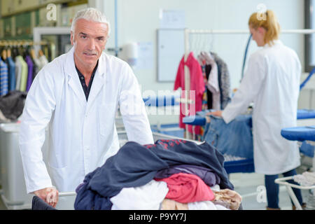 Mature man in professional laundry Stock Photo