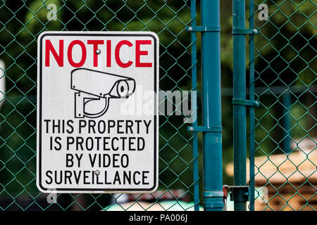 Notice private property video surveillance sign on chain link fence with icon Stock Photo