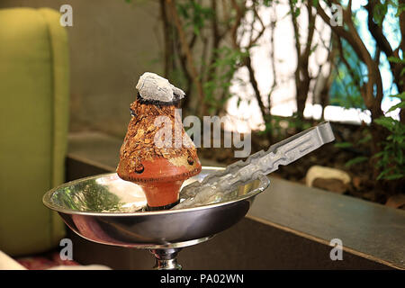 Ajami tobacco leaves burning in a hookah head Stock Photo