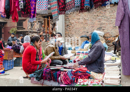 Locals shopping for fabric at an outdoor street market in Bhaktapur, Nepal Stock Photo