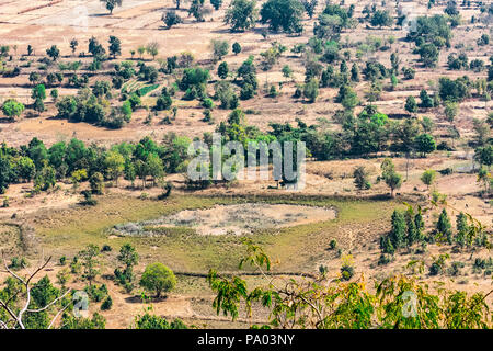 Indian farm fields and trees top arial view from the hills / mountain of a rural village of india. Stock Photo