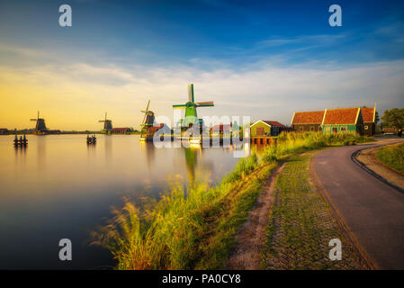 Sunset above farm houses and windmills of Zaanse Schans in the Netherlands Stock Photo