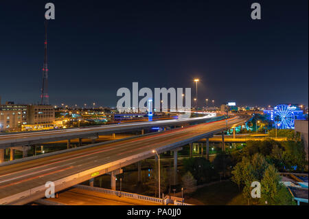 Streaking car lights at night on Interstate 45 through downtown Houston Stock Photo