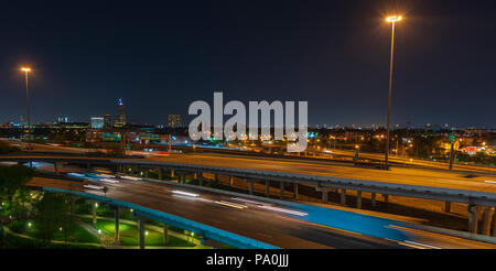 Streaking car lights at night on Interstate 45 through downtown Houston Stock Photo