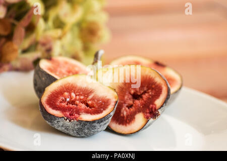 Figs in a plate on wooden table Stock Photo