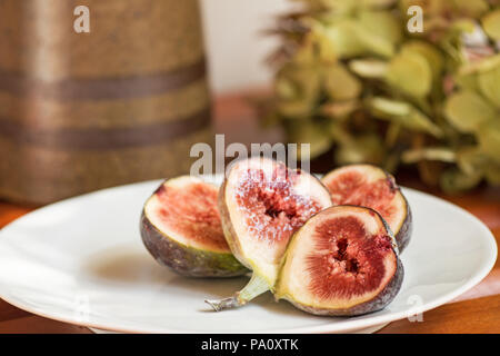 Figs in a plate on wooden table Stock Photo