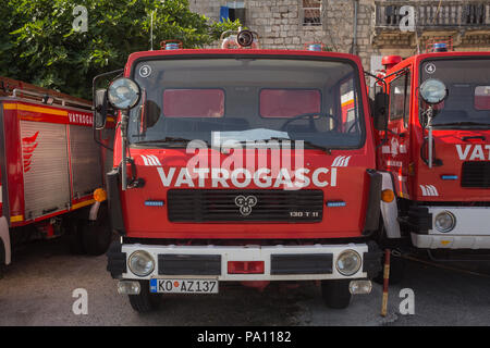 Bright red fire engine tender Vatrogasci (Firefighters) emergency service TAM 130 T11 vehicles parked in a line at Perast, Montenegro. Stock Photo