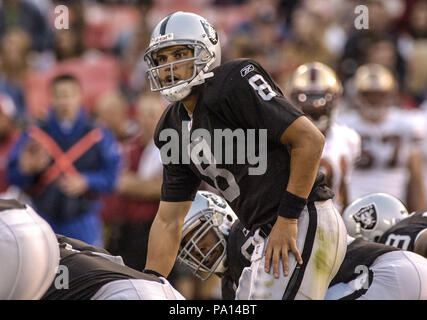 San Francisco, California, USA. 14th Aug, 2003. San Francisco 49ers  linebacker Julian Peterson (98) tackles Oakland Raiders quarterback Marques  Tuiasosopo (8) on Thursday, August 14, 2003, in San Francisco, California.  The 49ers