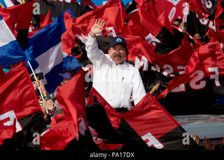 Managua, Nicaragua. 19th July, 2018. President Daniel Ortega (C) waving to supporters as he arrives to a celebration of the Sandinista Revolution's 39th anniversary. The Nicaraguan president has accused the country's Catholic church of being part of an attempted coup against his government. According to Ortega, the country's Catholic bishops aren't intermediaries in the political crisis, but rather part of a putschist conspiracy. Credit: Carlos Herrera/dpa/Alamy Live News Stock Photo