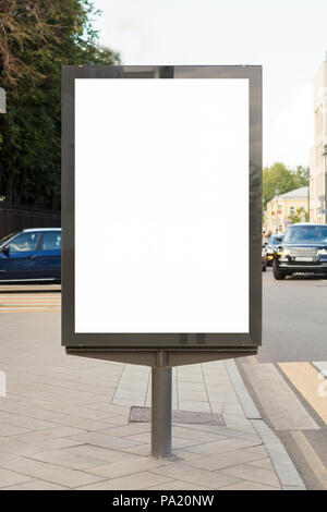 Blank vertical street billboard poster on city background. Stock Photo