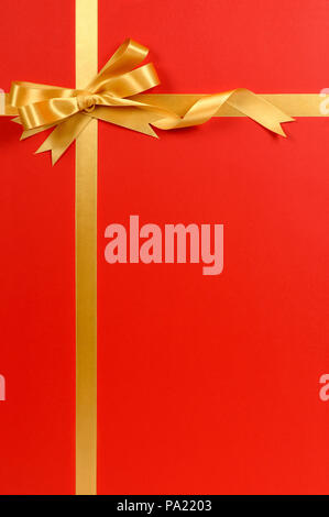 A thin curly gold ribbon for Christmas and birthday present banner isolated  against a white background Stock Photo - Alamy