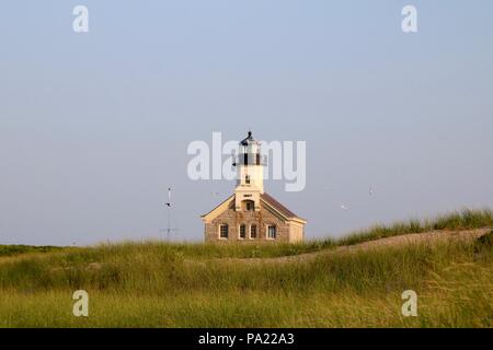 A view of the North Light on Block Islandsand dunes, Rhode Island across the dunes  from Sandy Point. Stock Photo
