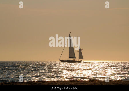 A sail boat off Sandy Point in Block Island, Rhode Island at sunset.in summer. Stock Photo