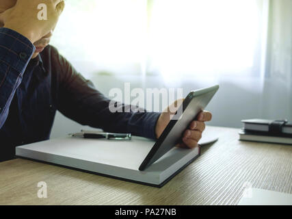Businessman using tablet to the situation on the market value , Business concept Stock Photo