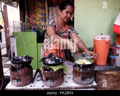 ANTIPOLO, RIZAL, PHILIPPINES - OCTOBER 21, 2015: Street food vendor sells snacks and other food items along a busy street in Antipolo City, Philippine Stock Photo