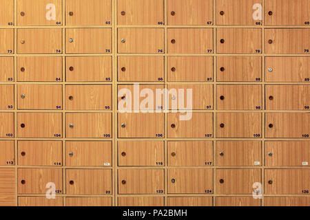 Wooden locker boxes, with metal locks in the post office. Stock Photo
