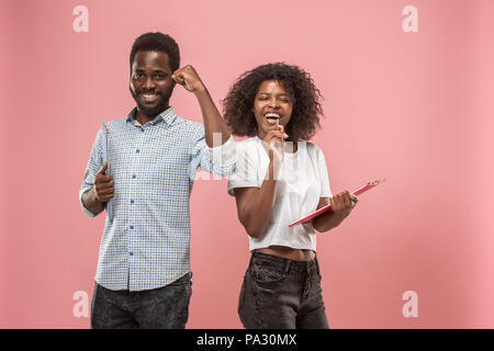 Two african students with folders in t-shirts together. Stylish girl with Afro hairstyle and her boyfriend. Stock Photo