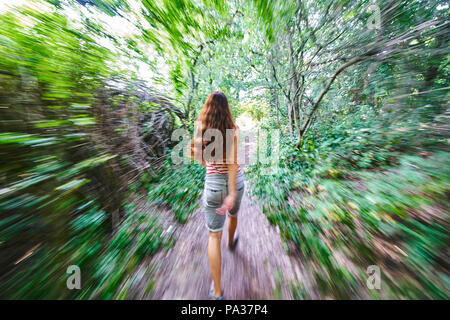 Woman running through a forest in Pfaffenhofen a.d.Ilm, Germany July 20, 2018 © Peter Schatz / Alamy Stock Photo Stock Photo