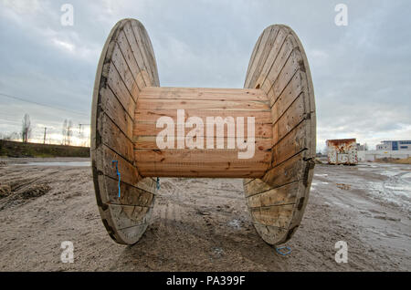 Empty wooden cable coil or spool for cable or rope standing on the side of  the road Stock Photo - Alamy
