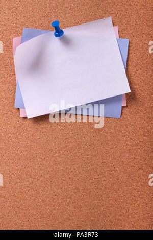 Several various colors sticky post notes vertical cork background Stock Photo