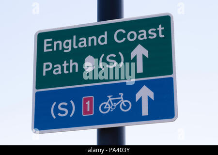 Sign for the England Coast Path at Tynemouth in England. The sign also points to a coastal bicycle route. Stock Photo
