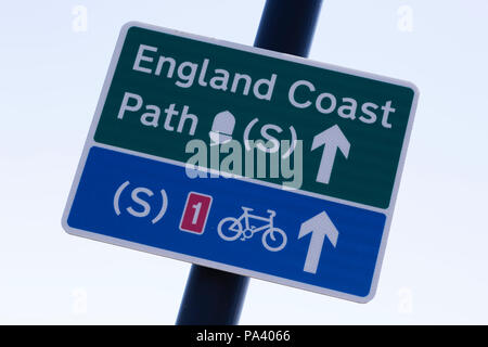 Sign for the England Coast Path at Tynemouth in England. The sign also points to a coastal bicycle route. Stock Photo