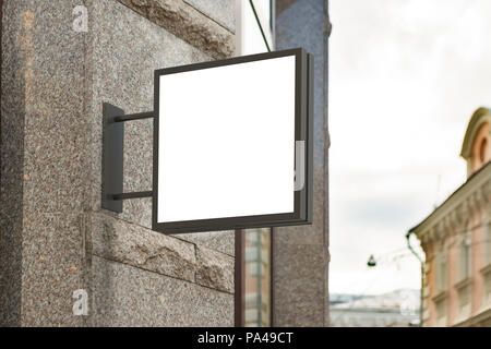 Blank shop sign on granite wall. Square signage mockup. Stock Photo