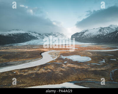 Vatnajokull glacier aerial drone image with street highway and clouds and blue sky. Dramatic winter scene of Vatnajokull National Park, Iceland, Europe. Beauty of nature concept background. Stock Photo