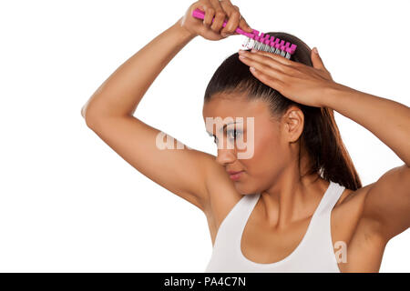young beautiful woman adjusts her pony tail Stock Photo